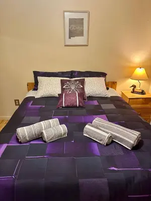 a large purple bed with two pillows on it at WOW!! Ultimate Pocono Retreat, Hot Tub, Game Room, Deck, Lakes, Skiing, Pools in Long Pond