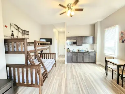 a bedroom with a bunk bed and a kitchen at Great Studio Apartment by Universities in Philadelphia