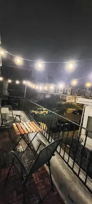 a balcony with a table and benches at night at Great Studio Apartment by Universities in Philadelphia