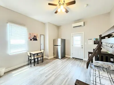 a living room with a refrigerator and a table at Great Studio Apartment by Universities in Philadelphia
