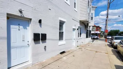 a white building with a white door on a street at Great Studio Apartment by Universities in Philadelphia