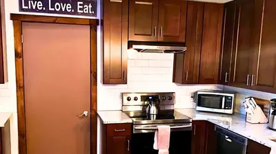 a kitchen with wooden cabinets and a stove top oven at March Giveaway: 3 Nights equal $50 Activity Credit in Albrightsville
