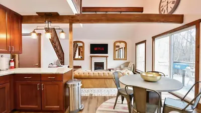 a kitchen and living room with a table and chairs at March Giveaway: 3 Nights equal $50 Activity Credit in Albrightsville