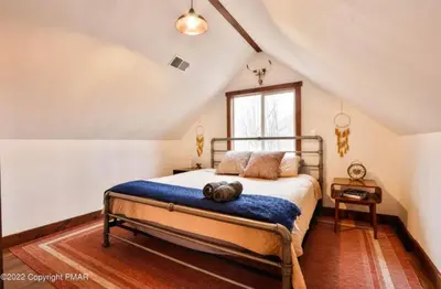 a bedroom with a large bed in a attic at March Giveaway: 3 Nights equal $50 Activity Credit in Albrightsville