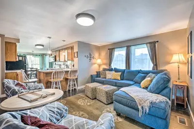 a living room with a blue couch and a table at Deck and Game Room Home in Pennsylvania Countryside in Klingerstown
