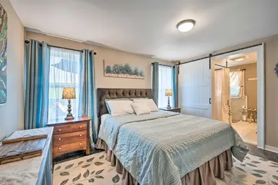 a bedroom with a large bed and a window at Deck and Game Room Home in Pennsylvania Countryside in Klingerstown
