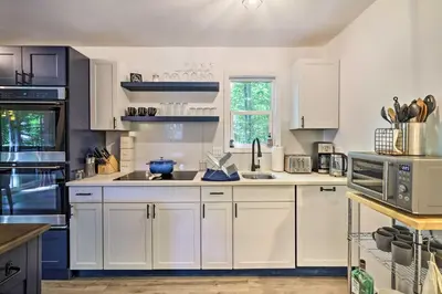 a kitchen with white cabinets and a sink at Chic Tobyhanna Home with Furnished Deck Space! in Tobyhanna