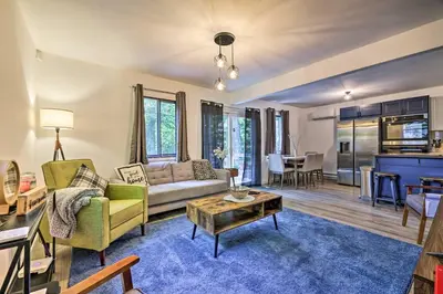 a living room with a couch and a table at Chic Tobyhanna Home with Furnished Deck Space! in Tobyhanna