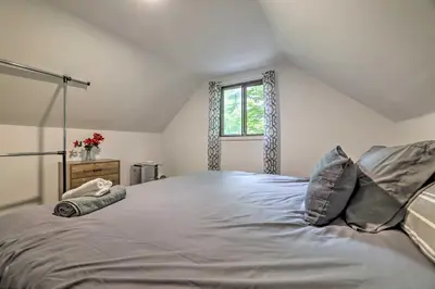 a large bed in a room with a window at Chic Tobyhanna Home with Furnished Deck Space! in Tobyhanna