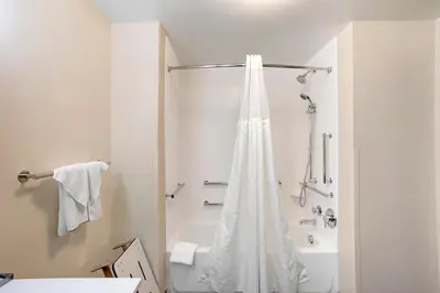 a white bathroom with a shower and a tub at Sleep Inn North - Central York in York