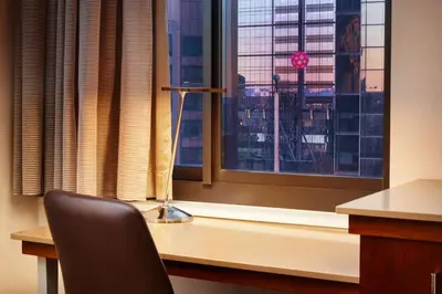 a desk with a chair in front of a window at Hilton New York Times Square in New York