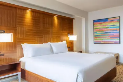 a large white bed in a hotel room at Hilton New York Times Square in New York