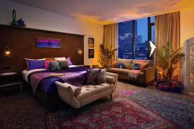a bedroom with a bed and a couch in a room at Hilton New York Times Square in New York