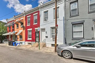 a silver car parked in front of a row of houses at Philly Townhome with Gas Grill about 5 Mi to Dtwn! in Philadelphia