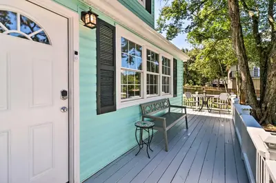 a green house with a bench on the front porch at Game Room, Community Beach Pocono Home! in Albrightsville