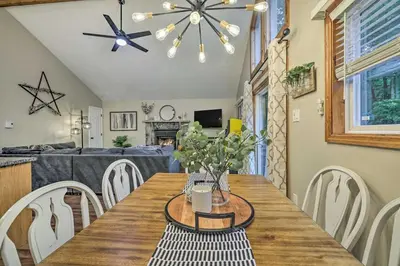 a dining room with a wooden table and chairs at Charming Albrightsville Home with Gas Fire Pit! in Albrightsville
