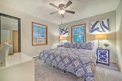 a bedroom with a bed and a ceiling fan at Charming Albrightsville Home with Gas Fire Pit! in Albrightsville