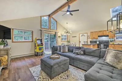 a living room with a couch and a table at Charming Albrightsville Home with Gas Fire Pit! in Albrightsville
