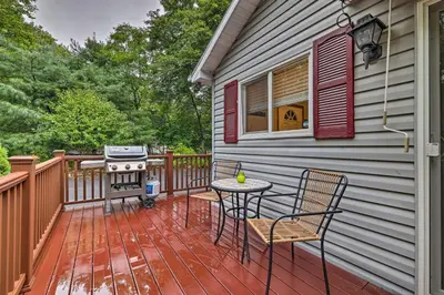 a deck with a grill and a table and chairs at Charming Albrightsville Home with Gas Fire Pit! in Albrightsville