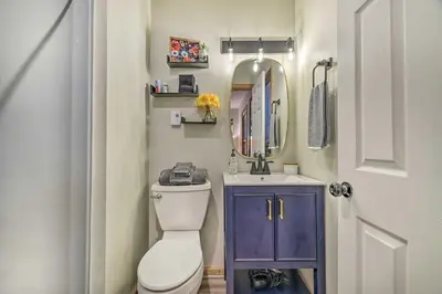 a bathroom with a toilet and a sink and a mirror at Charming Albrightsville Home with Gas Fire Pit! in Albrightsville