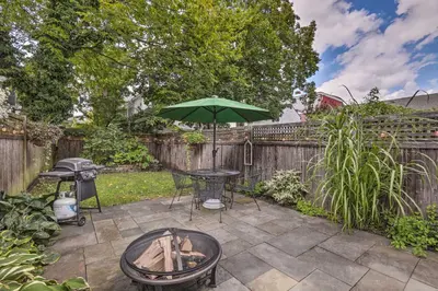 a patio with a table and an umbrella at Charming Lambertville Retreat - 1 Mi to River! in Lambertville