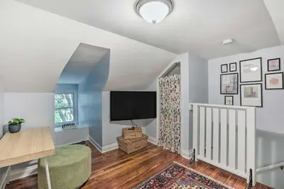 a living room with a tv and a chair at Charming Lambertville Retreat - 1 Mi to River! in Lambertville