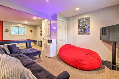 a living room with a large red bean bag at Walk to Lake Game Room Getaway in Pocono Summit! in Pocono Summit