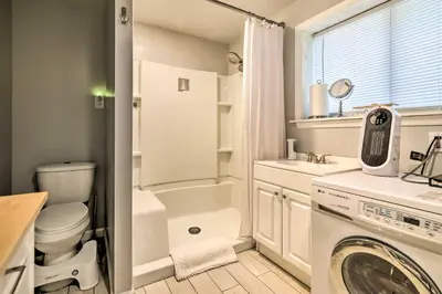 a bathroom with a washing machine and a washer at Walk to Lake Game Room Getaway in Pocono Summit! in Pocono Summit