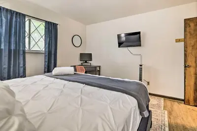 a bedroom with a bed and a tv on the wall at Walk to Lake Game Room Getaway in Pocono Summit! in Pocono Summit