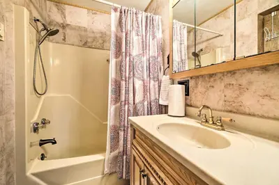 a bathroom with a sink and a tub and a shower at Walk to Lake Game Room Getaway in Pocono Summit! in Pocono Summit