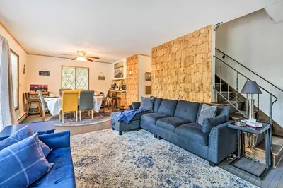 a living room with a couch and a table at Walk to Lake Game Room Getaway in Pocono Summit! in Pocono Summit