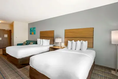 a hotel room with two beds and a couch at MainStay Suites North - Central York in York