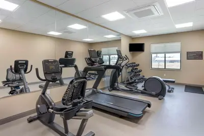 a gym with treadmills and elliptical machines at MainStay Suites North - Central York in York