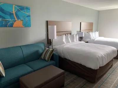 a hotel room with a bed and a couch at MainStay Suites North - Central York in York