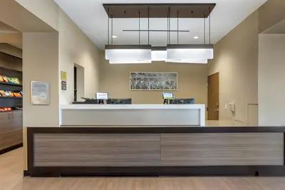 an office lobby with a reception desk and lights at MainStay Suites North - Central York in York