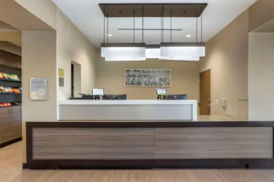 an office lobby with a reception desk and lights at MainStay Suites North - Central York in York