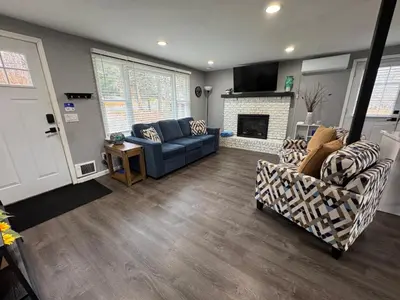 a living room with a blue couch and a fireplace at Casa Rosado @ Pocono II by Lake Hot Tub Camelback in Tobyhanna