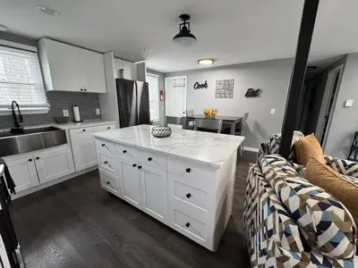 a kitchen with white cabinets and a counter top at Casa Rosado @ Pocono II by Lake Hot Tub Camelback in Tobyhanna