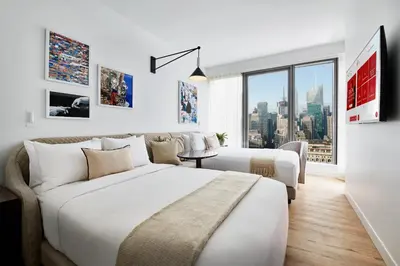a hotel room with two beds and a window at Virgin Hotels New York City in New York