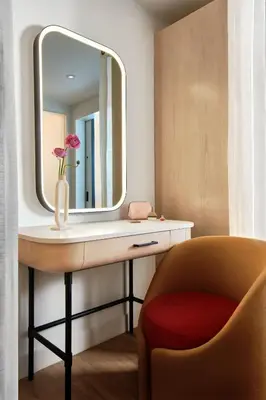 a dressing table with a mirror and a chair at Virgin Hotels New York City in New York