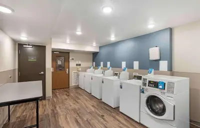 a laundry room with a row of washers and dryers at Extended Stay America Suites - Philadelphia - Plymouth Meeting - West in Plymouth Meeting