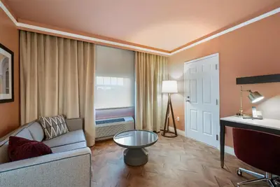 a living room with a couch and a window at The Inn at Lewisburg, BW Signature Collection in Lewisburg