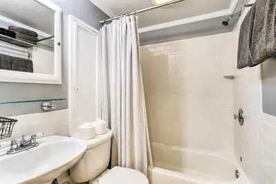 a bathroom with a sink and a toilet and a shower at Historic Home with Garden Walk to Center City! in Philadelphia
