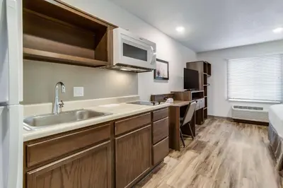 a kitchen with a sink and a microwave at WoodSpring Suites Harrisburg Linglestown in Harrisburg