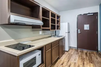 a kitchen with a stove and a refrigerator at WoodSpring Suites Harrisburg Linglestown in Harrisburg