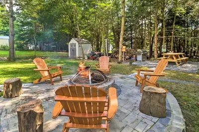 a group of chairs sitting around a fire pit at Game Room and Yard Family Paradise in Pocono Summit in Pocono Summit Estates