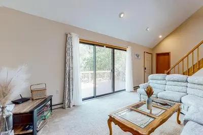 a living room with a couch and a table at House in the Woods in Albrightsville