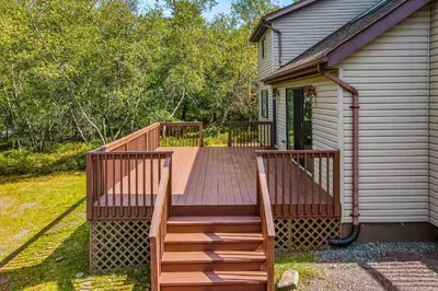 a wooden deck on the side of a house at House in the Woods in Albrightsville