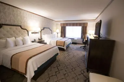 a hotel room with two beds and a television at Best Western Plus Fairfield Executive Inn in Fairfield