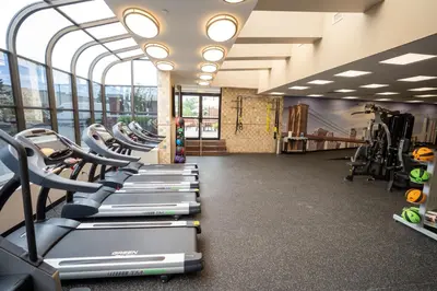 a gym with rows of treadmills and machines at Best Western Plus Fairfield Executive Inn in Fairfield